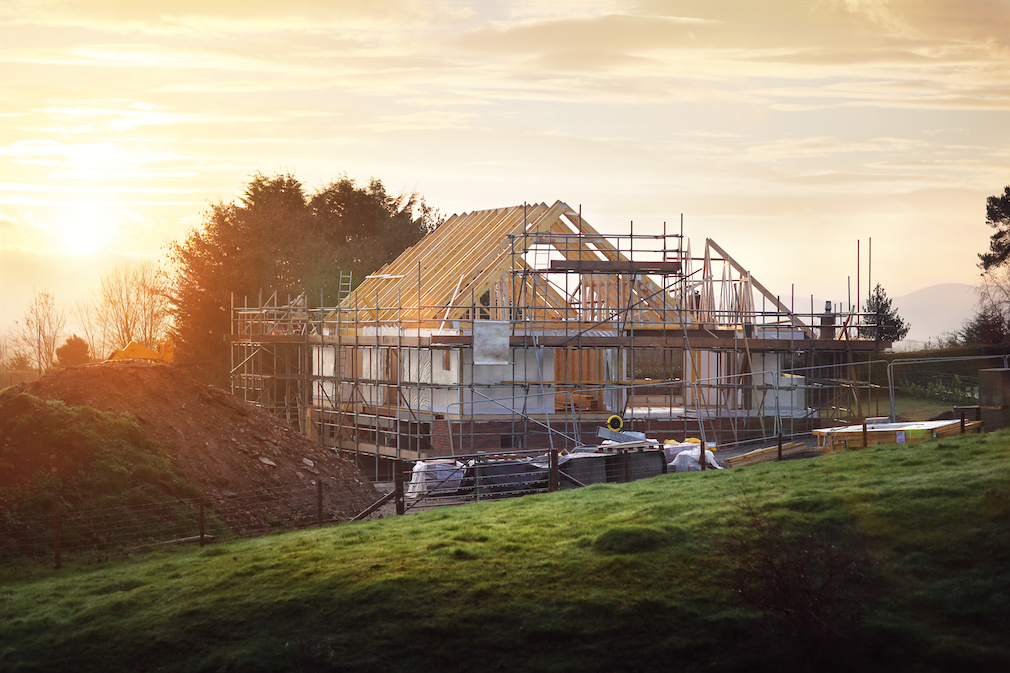 Building site with house under construction