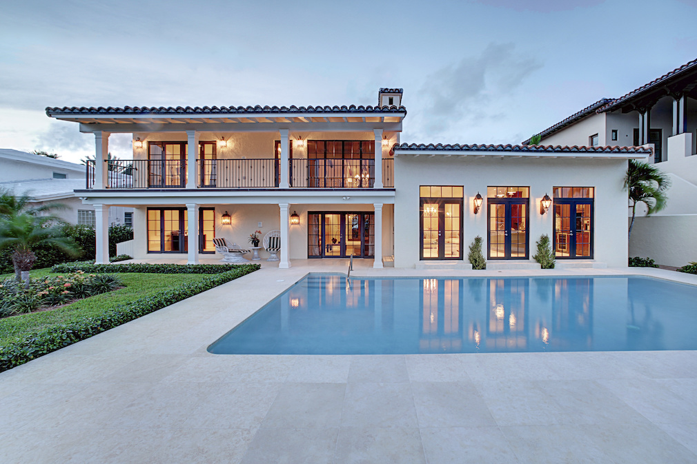 Spectacular Backyard Swimming Pool Designer home. Beautiful Exterior of New Home at Twilight