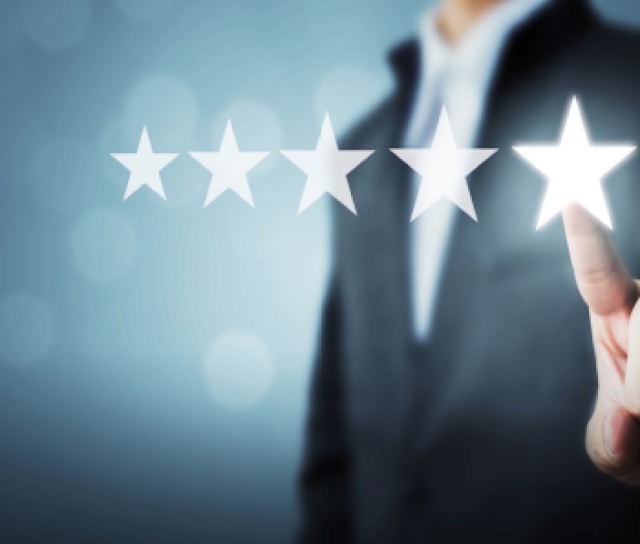 Businessman pointing five star symbol to increase rating of company