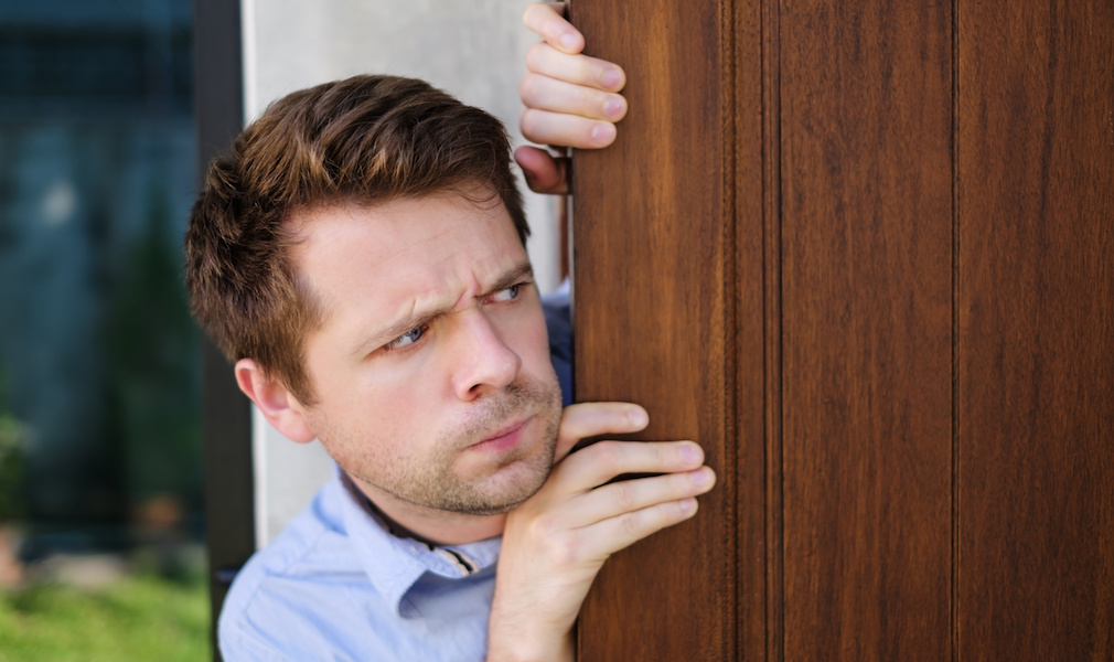 man looking out door