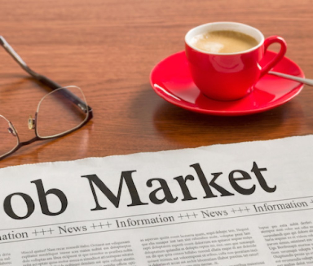 A newspaper on a wooden desk - Job Market
