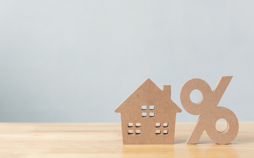 Percentage and house sign symbol icon wooden on wood table with white background