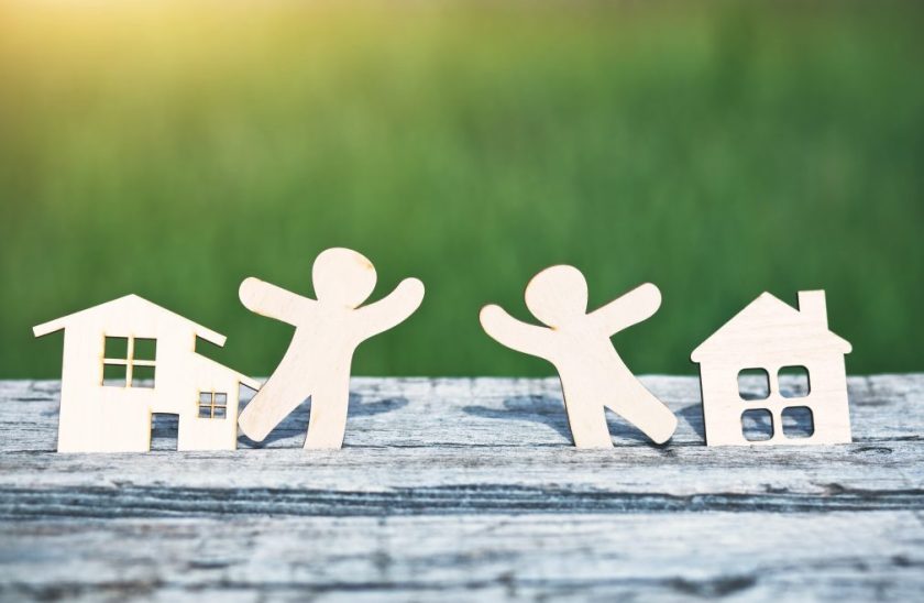 little wooden men in houses. Symbol of neighborhood, friendship, teamwork and sweet home concept