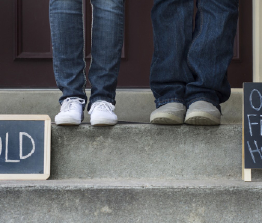 couple on doorstep of new home