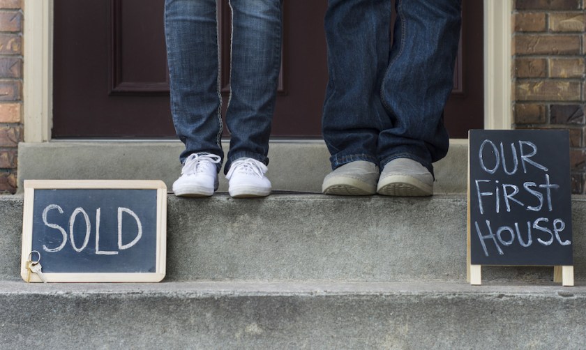 couple on doorstep of new home