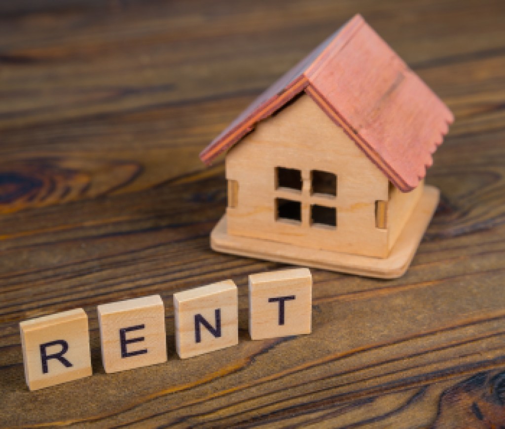 Concept rental house. Wooden house and text on the cubes Rent.