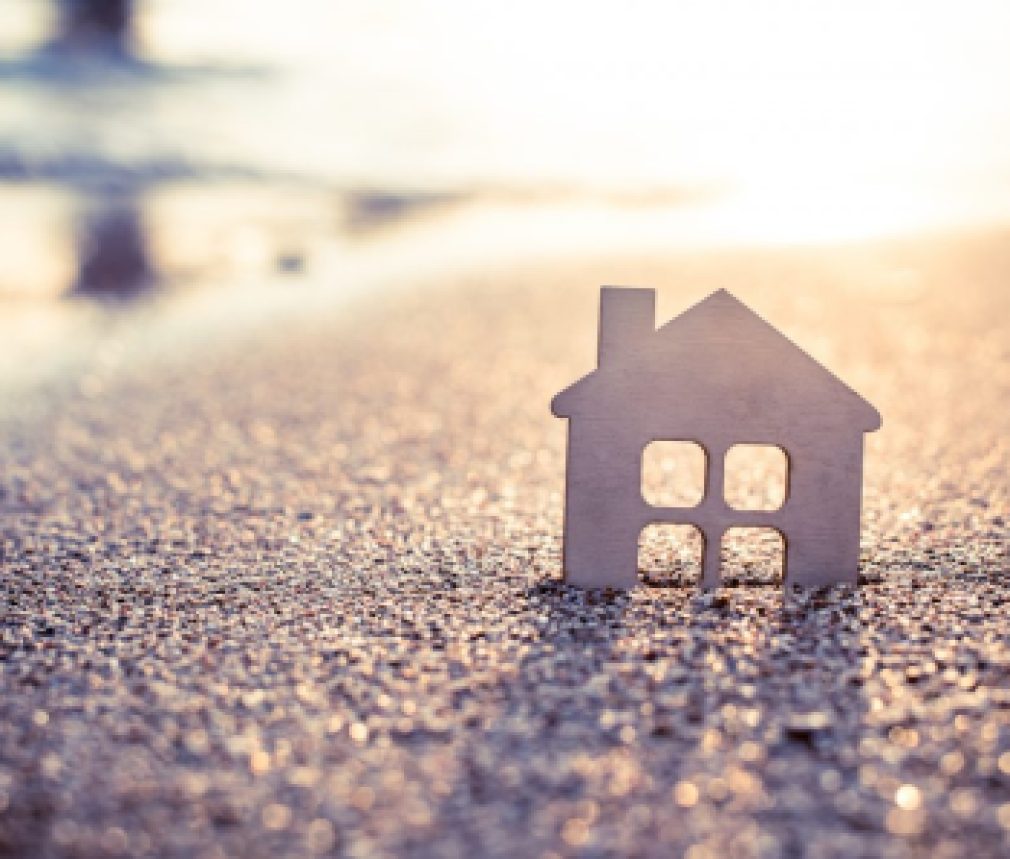 symbol of the house at sunset on the seashore