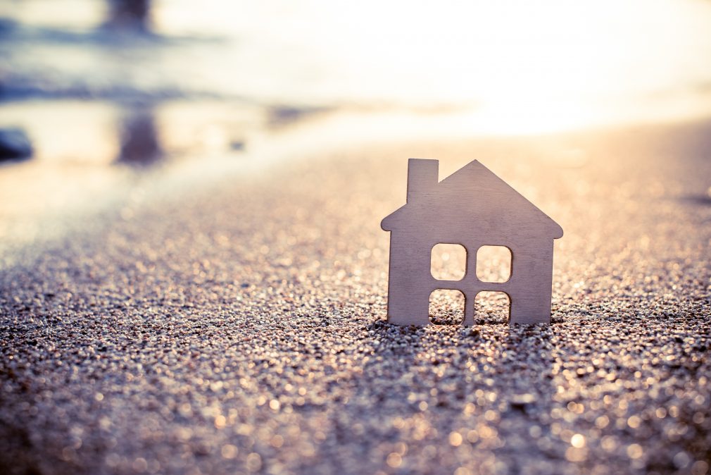 symbol of the house at sunset on the seashore