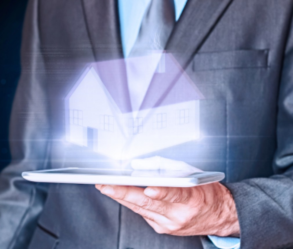 Businessman holding a virtual house. Virtual Holographic House. Business, mortgages and families concept