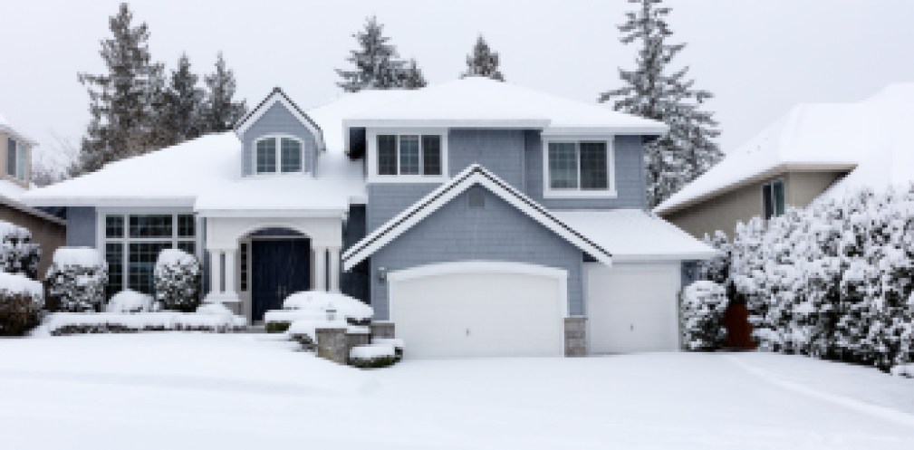 Snowing with residential Pacific Northwest home in background