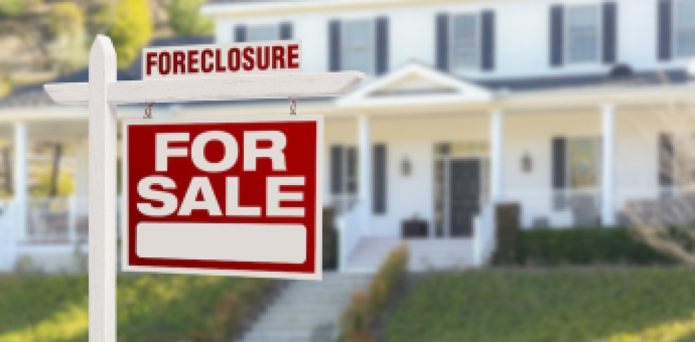 Foreclosure Home For Sale Real Estate Sign in Front of Beautiful Majestic House.