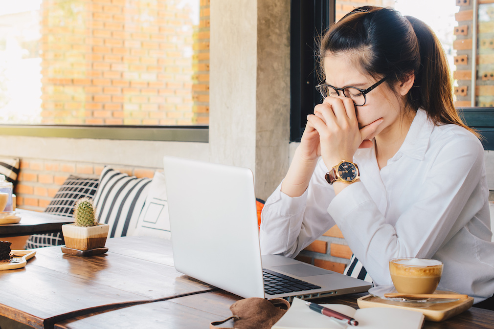 Asian businesswoman worry about her working on her laptop in office.