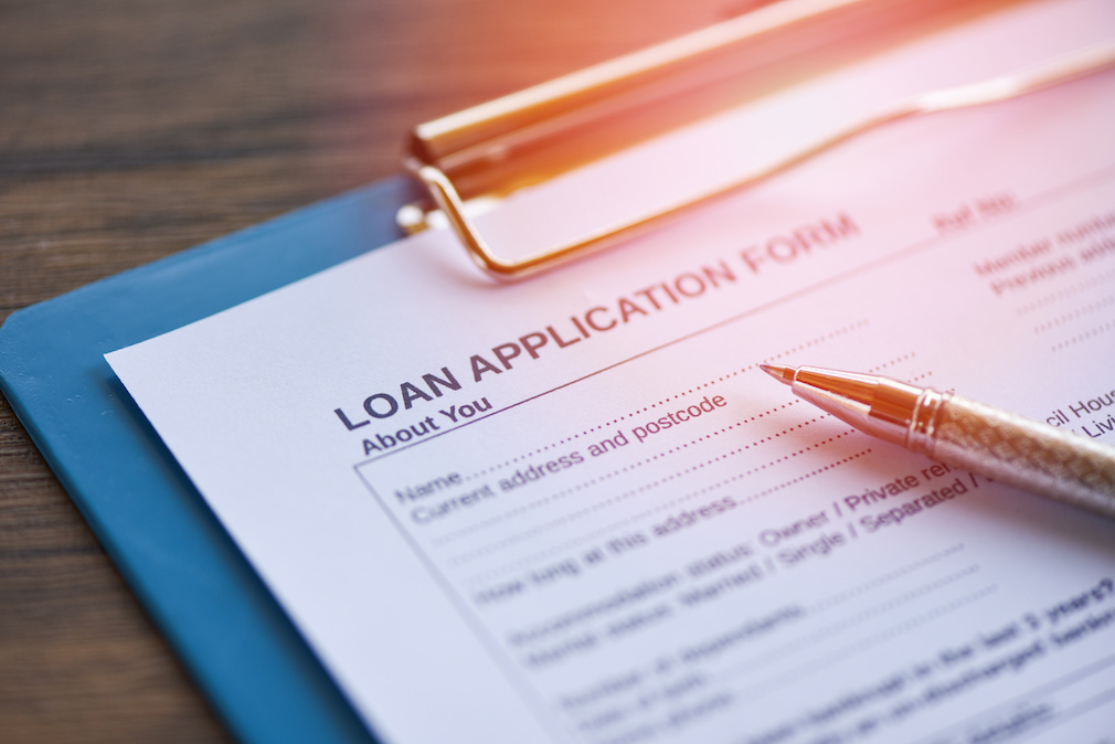 Loan application form with pen on paper / financial loan negotiation for lender and borrower