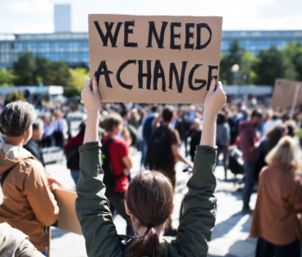 Rear view of people with placards and posters on global strike for climate change.