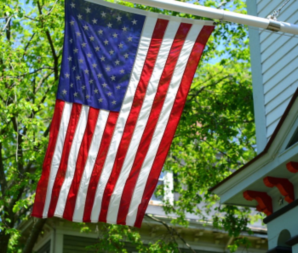 American Flag Outside A House In Small Town USA