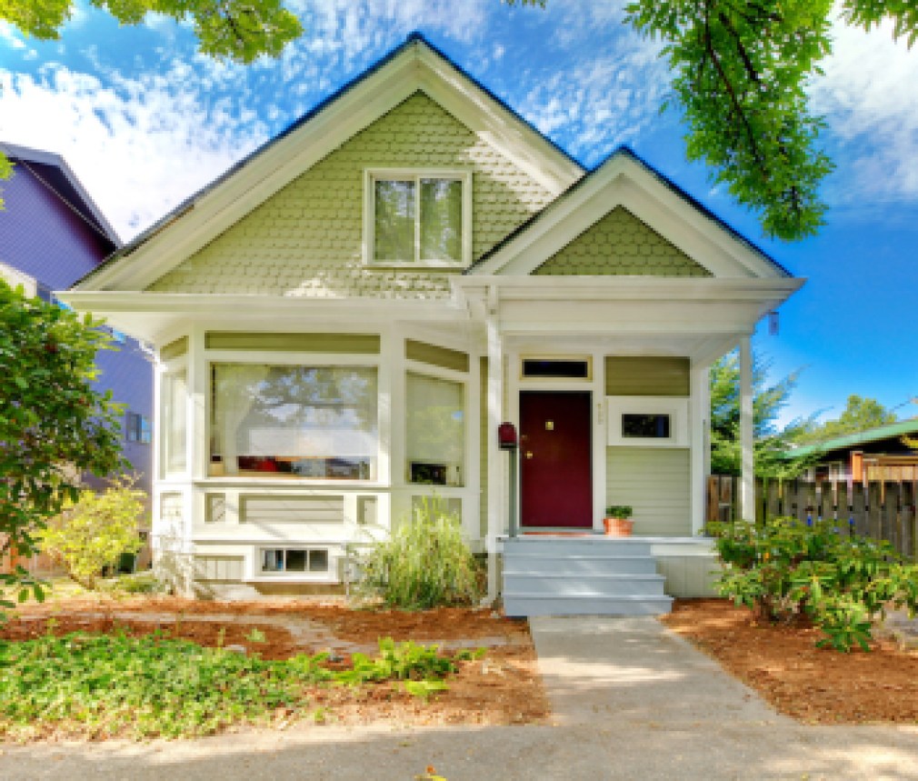 Small cute craftsman American house wth green and white.