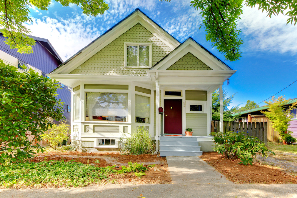 Small cute craftsman American house wth green and white.