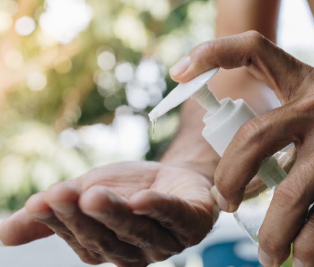 Close Up man using a hand sanitizer