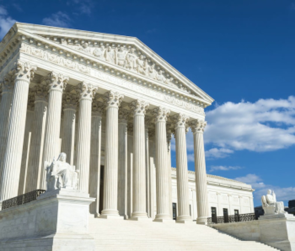 Supreme Court of the United States building front entrance with a scenic view of columns and steps under bright summer sun in Washington DC, USA