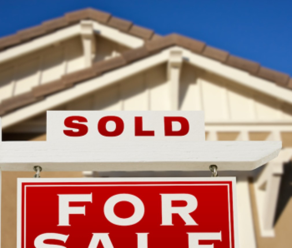 Sold Home For Sale Real Estate Sign and House.