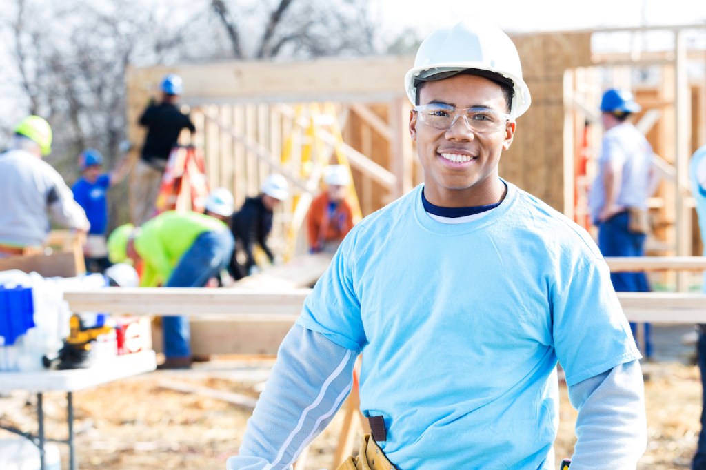 Confident volunteer construction foreman at work site