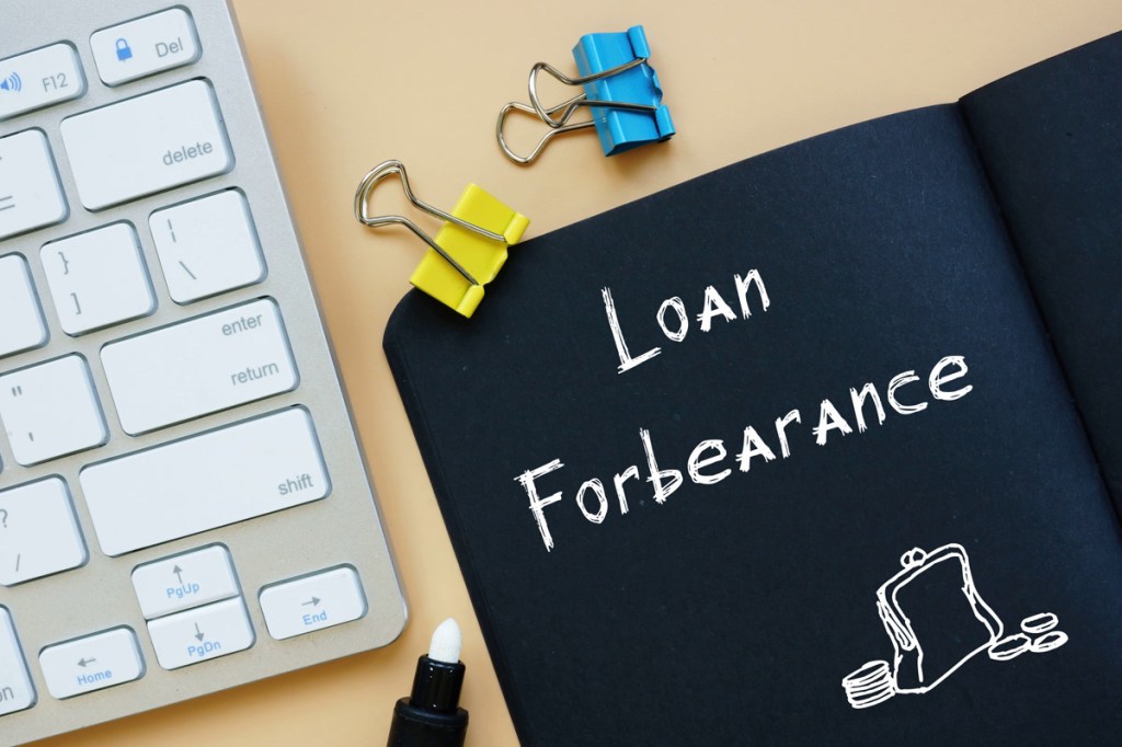 Business concept meaning Loan In Forbearance with sign on the page.