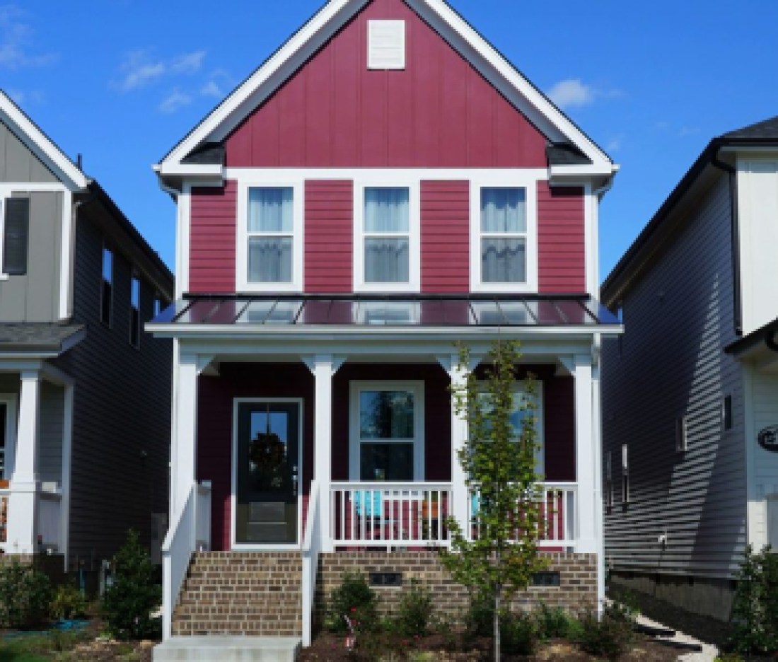 Two story, red, row house in a suburban neighborhood in North Carolina