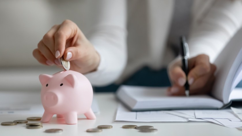 Close up of woman saving money managing home finances
