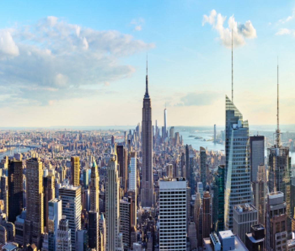 New York City skyline from roof top with urban skyscrapers before sunset.