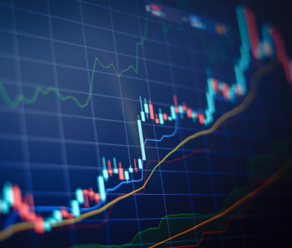 Closeup financial chart with uptrend line candlestick graph in stock market on blue color monitor background