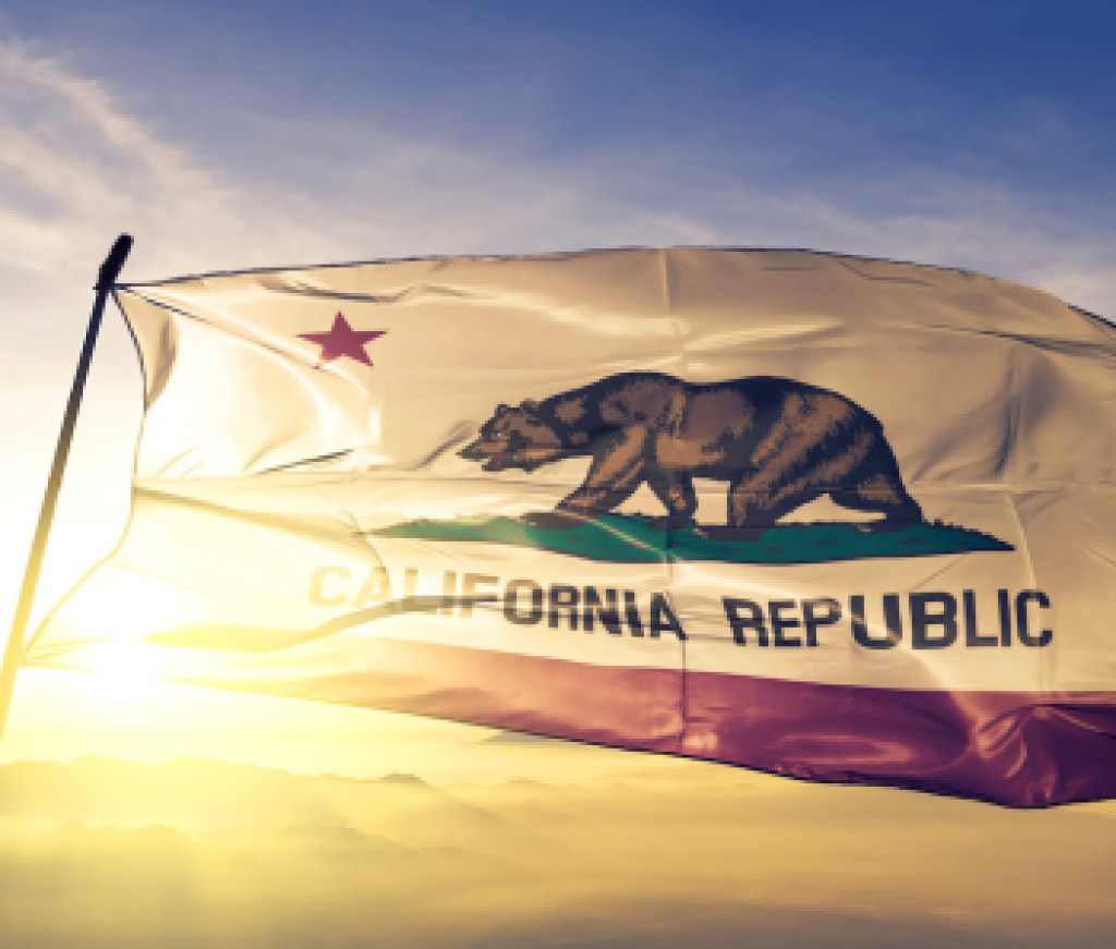 California state of United States flag waving on the top sunrise mist fog
