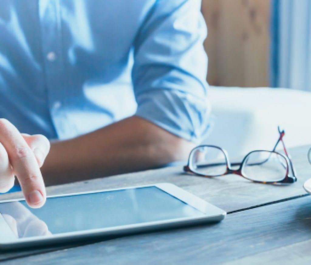 man using digital tablet computer, close up of the hand, business and technology background with copy space