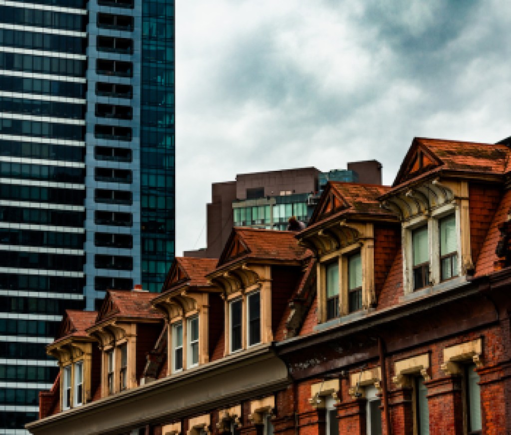The Tops of Old Brick Buildings Surrounded by Skyscrapers in Downtown Toronto