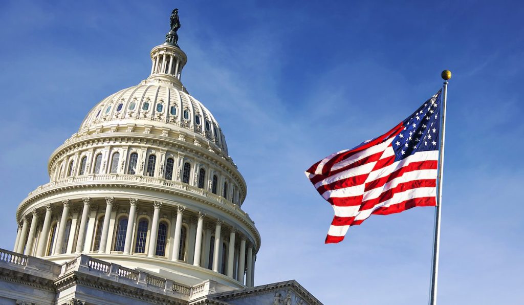 American flag waving with the Capitol Hill