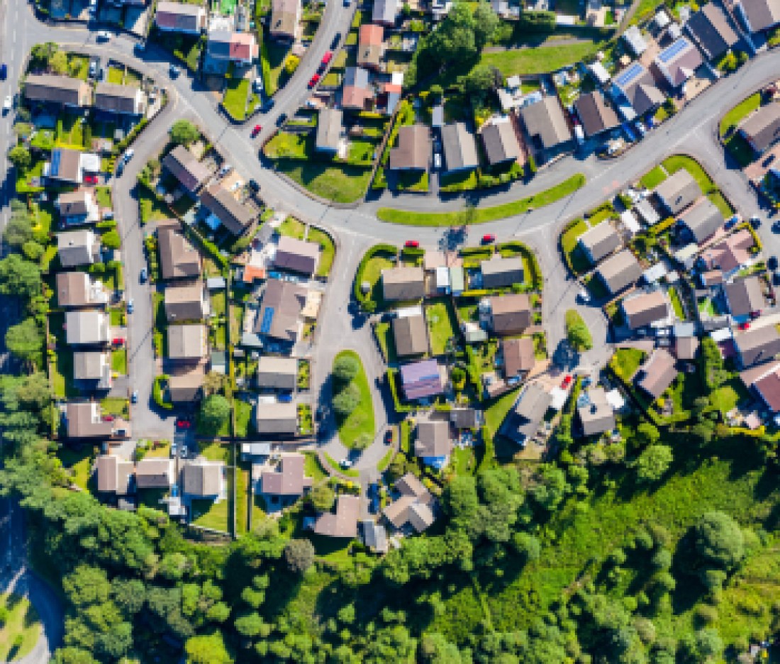 Aerial drone view of small winding sreets and roads in a residential area of a small town
