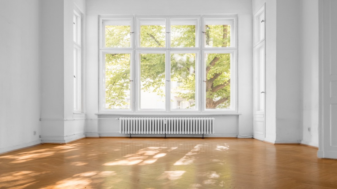 empty room in old apartment building with  parquet floor and big wooden windows