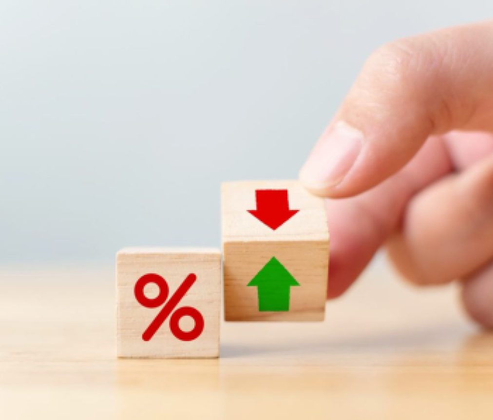 Interest rate financial and mortgage rates concept. Hand flip wood cube change arrow down to up