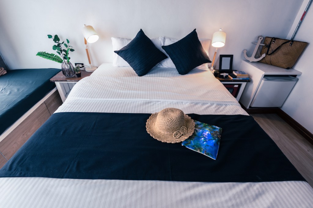 A bedroom with white wall ,look comfy and relax.