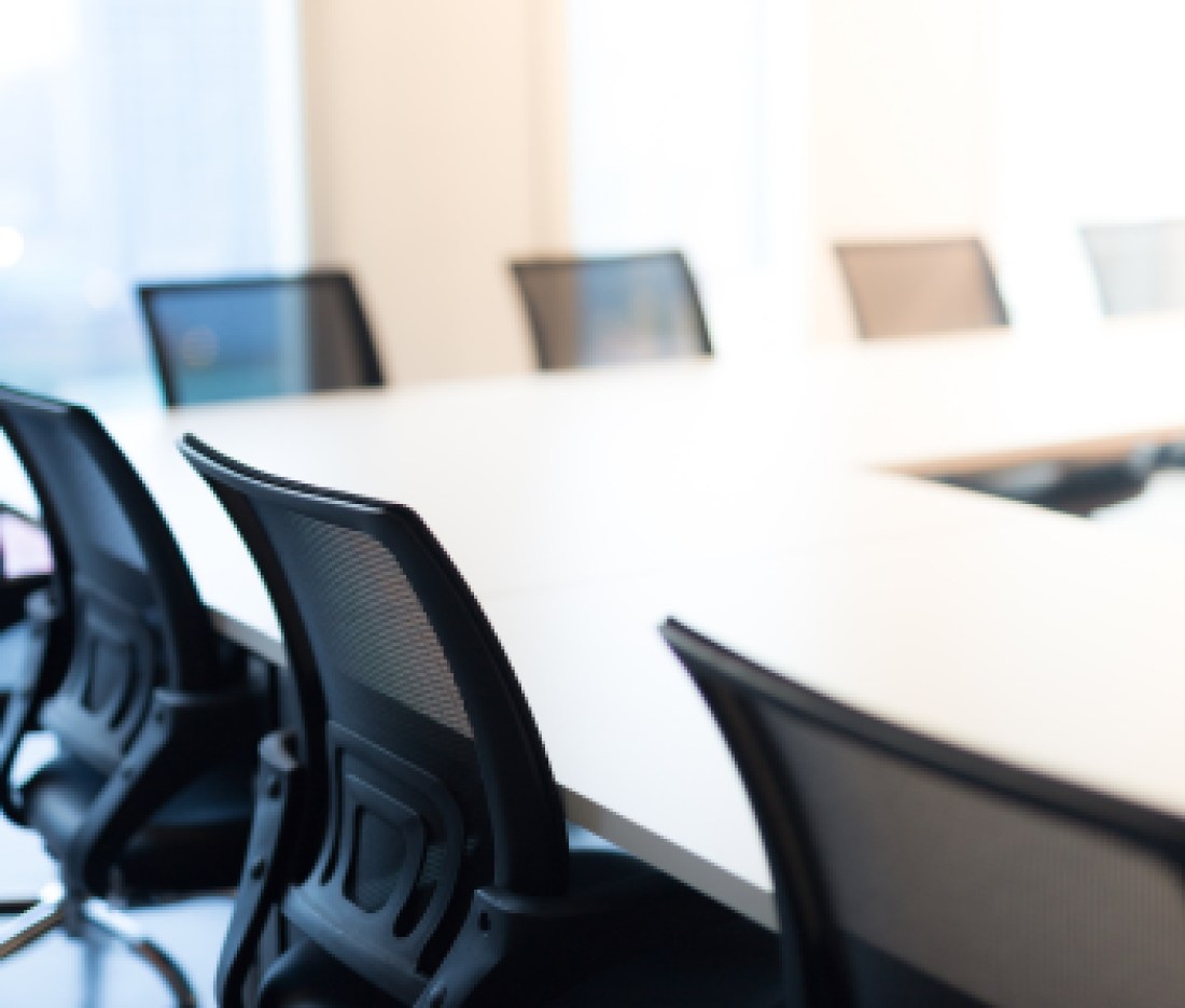 Modern meeting room with large windows, view back chair, outside building, city, tower view, soft focus.