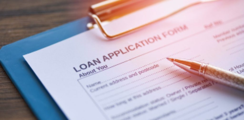 Loan application form with pen on paper / financial loan negotiation for lender and borrower