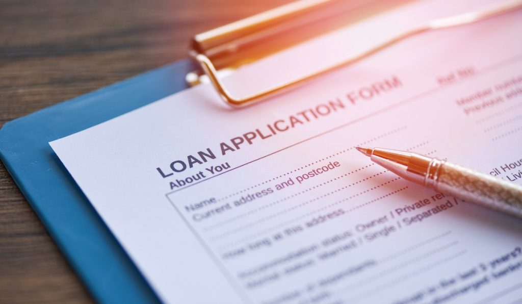 Loan application form with pen on paper / financial loan negotiation for lender and borrower