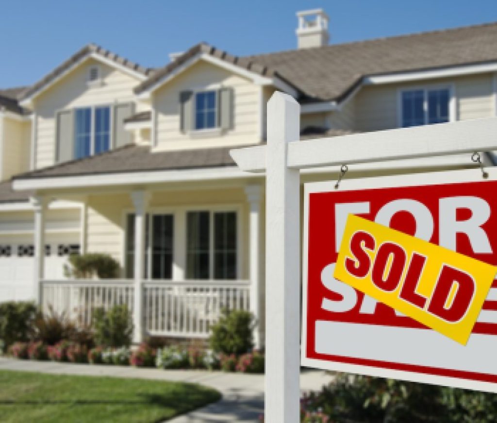 Sold Home For Sale Sign in Front of Beautiful New House.