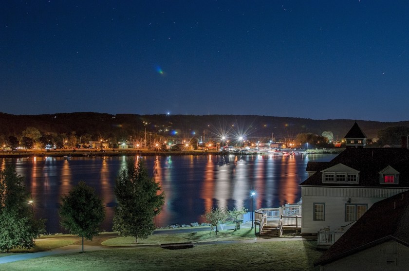 Beautiful shot of buildings with lit lights in the distance at night time in Michigan