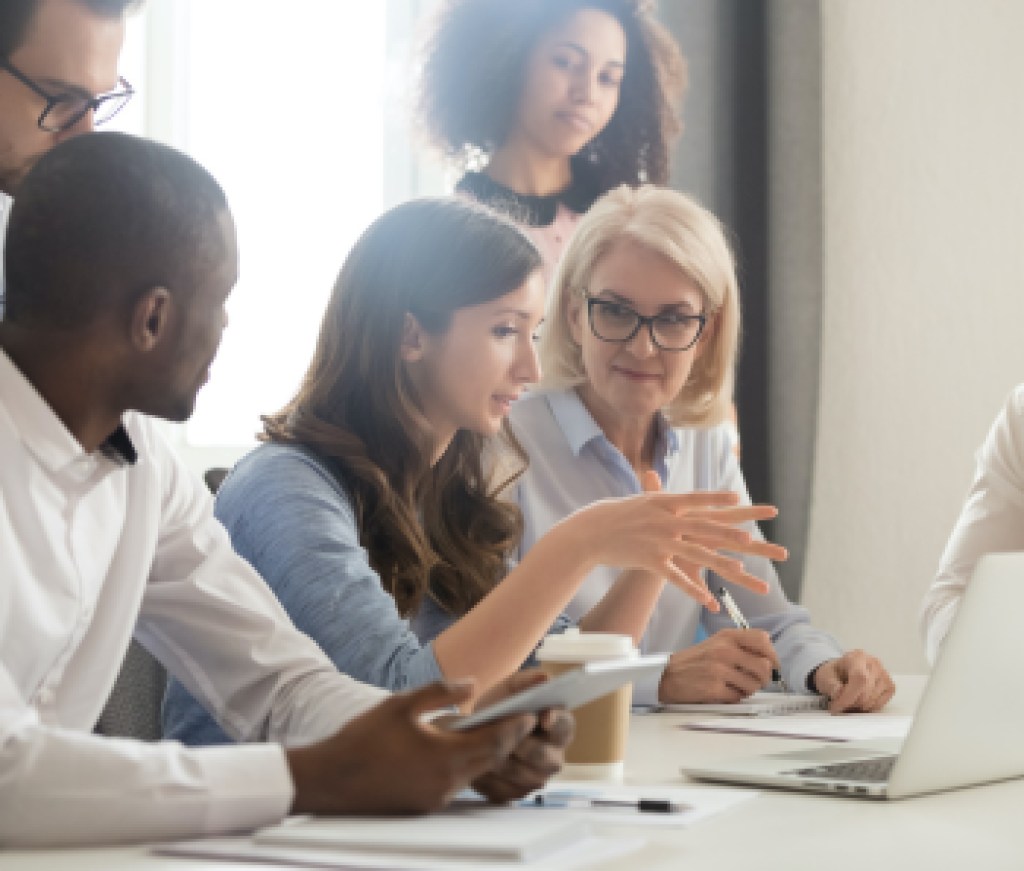 Female mentor teaching employees group analyzing online project explaining strategy