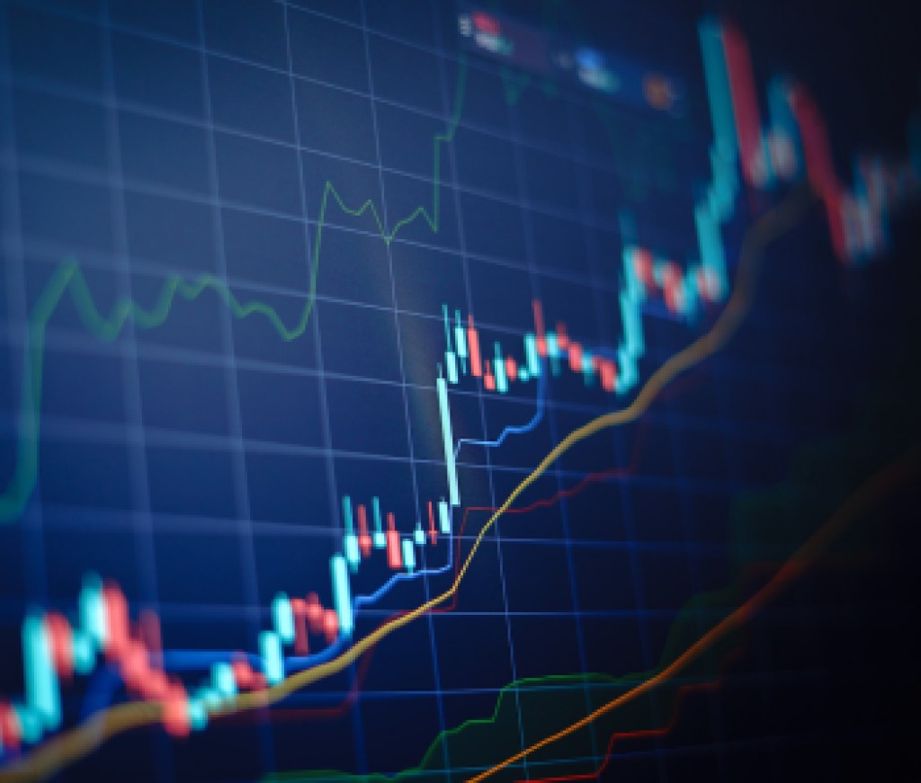 Closeup financial chart with uptrend line candlestick graph in stock market on blue color monitor background