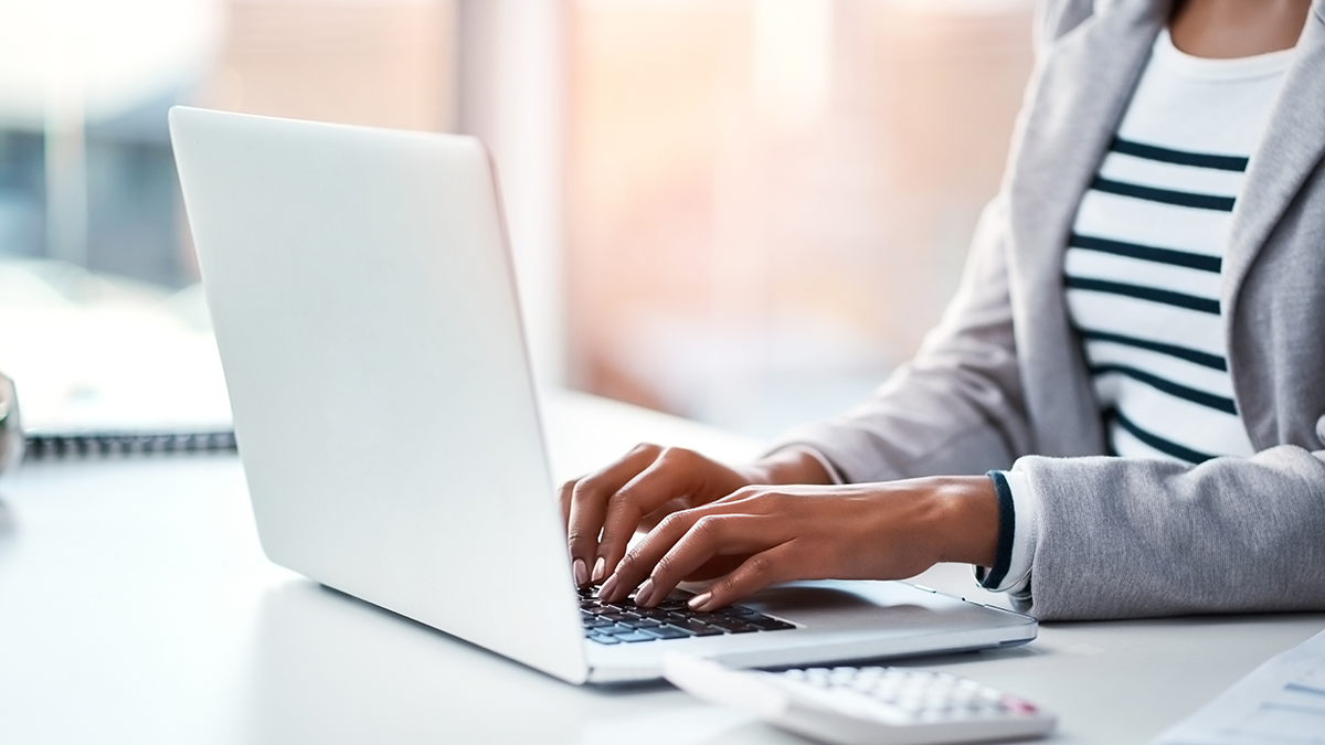 Woman preparing a report using a laptop