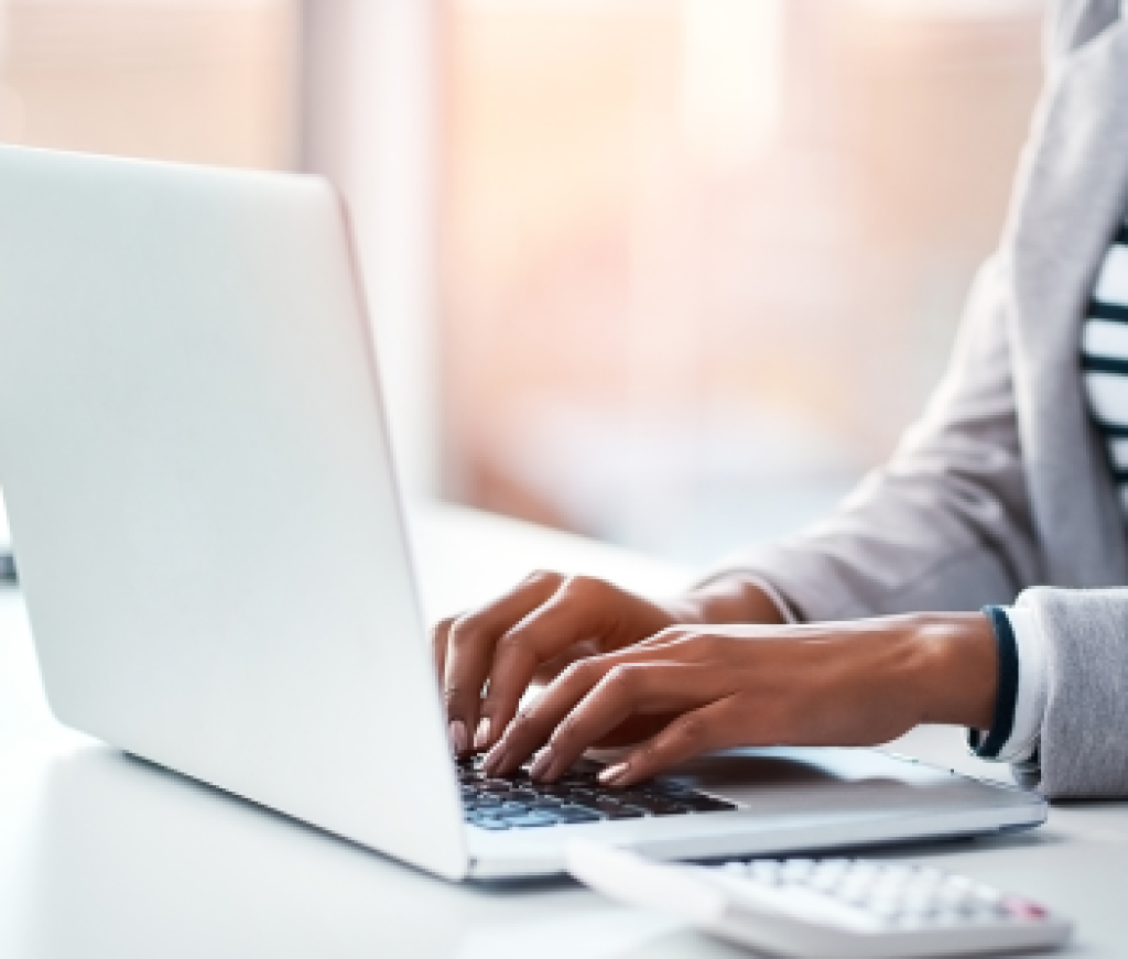 Woman preparing a report using a laptop