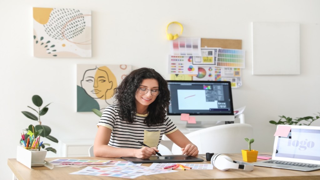 Young female designer working in office