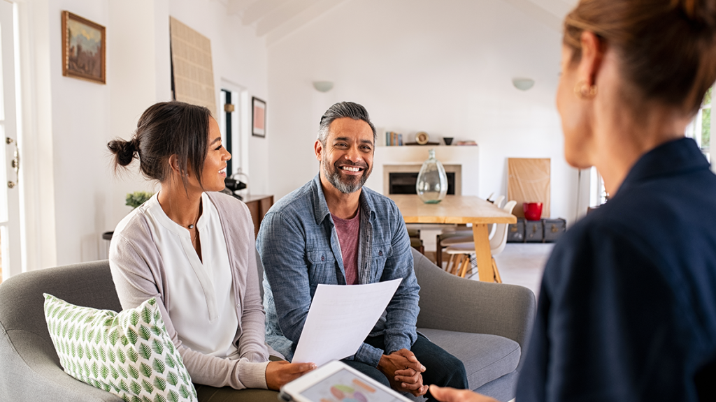 Couple meets with financial advisor in their living room