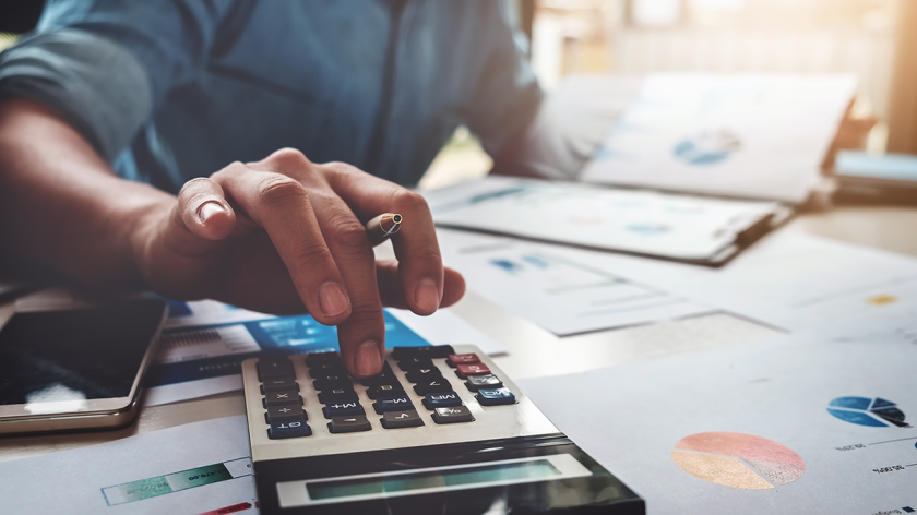 Home buyer calculating their budget on a calculator